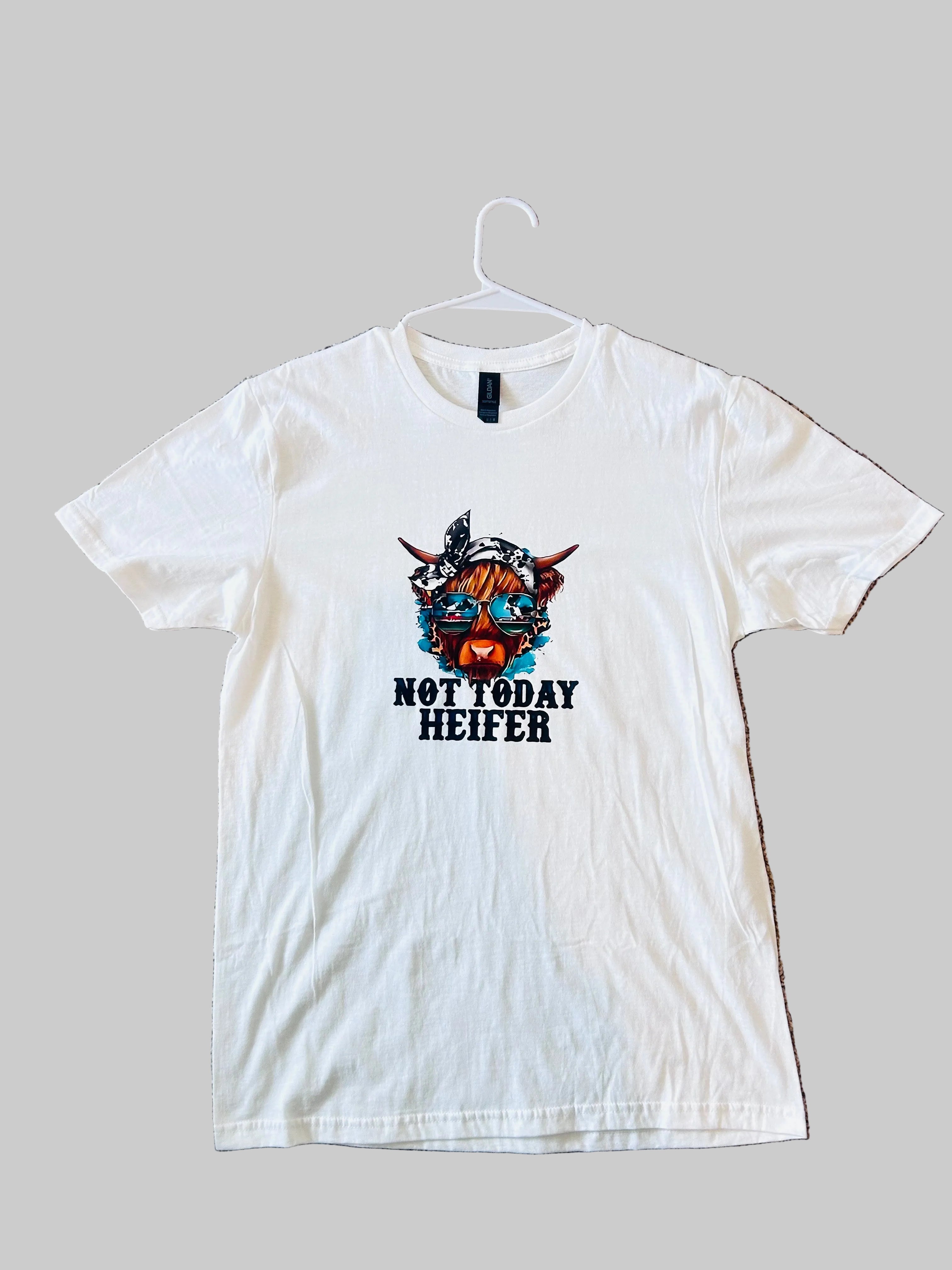 White t-shirt with 'Not Today Heifer' graphic on a beige carpet