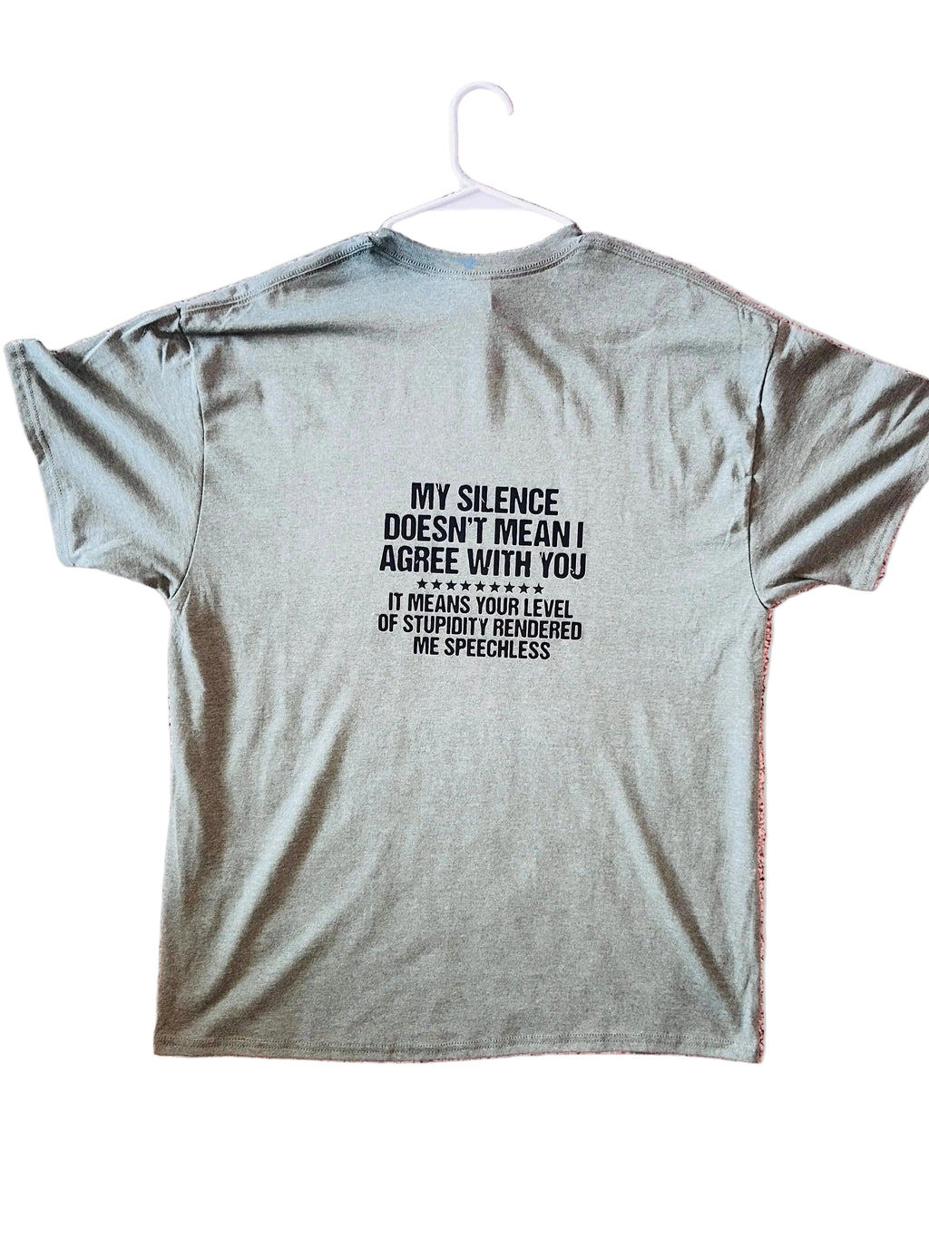 Gray t-shirt with a printed message on a pink textured background